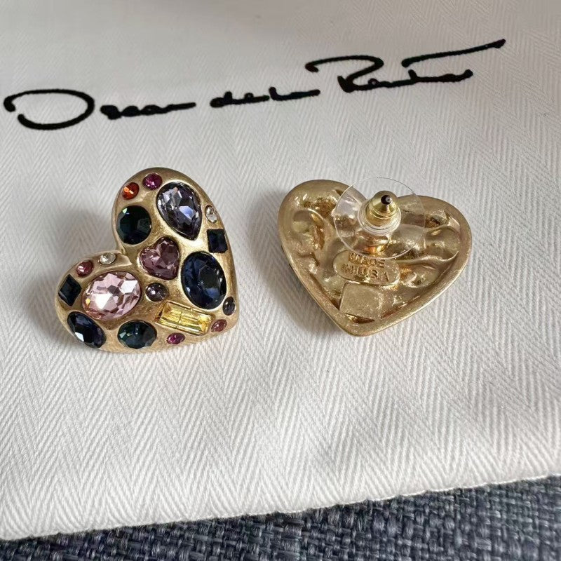 Heart-shaped crystal stud earrings with gold tone back, featuring pink and blue stones