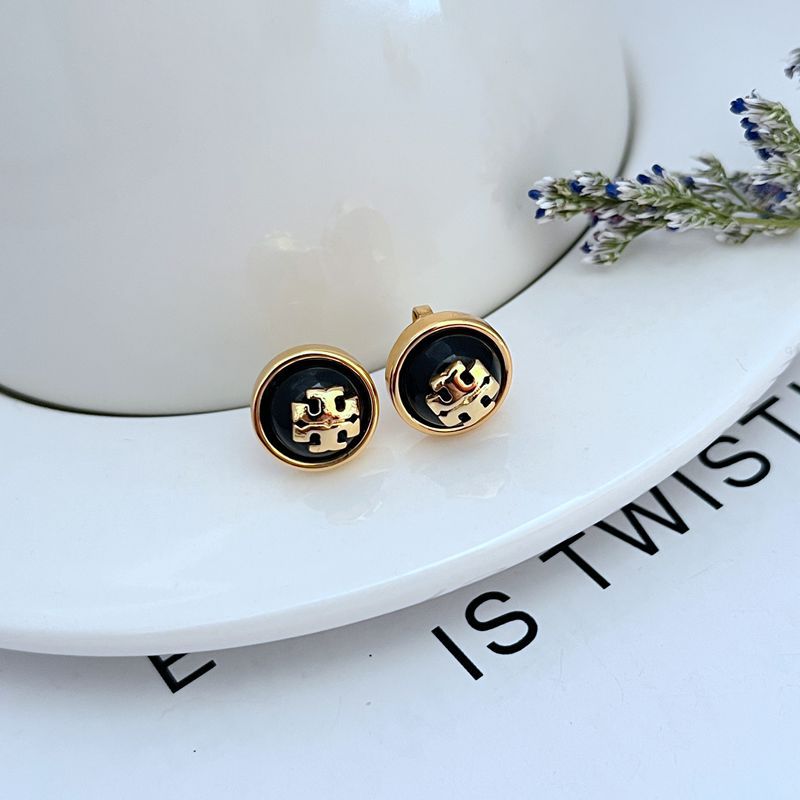 Gold-tone round resin logo stud earrings, black face with logo emblem