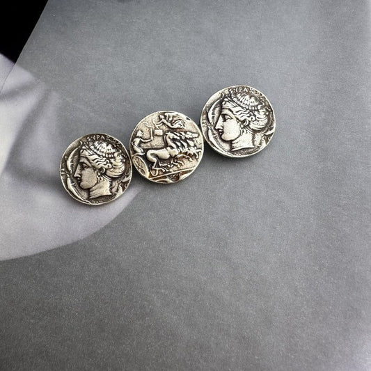 Silver-tone coin brooch with three round profile coins in aged finish