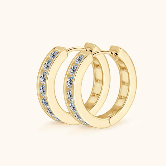Gold hoop earrings with round bezel moissanite stones lining the front