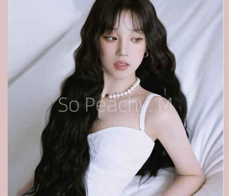Freshwater pearl necklace worn by model with gold logo pendant at center
