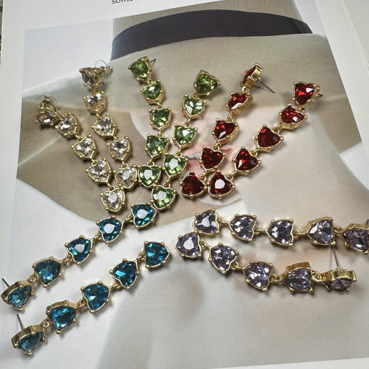 Heart-shaped crystal drop earrings with gold-tone links and mixed-color crystals.