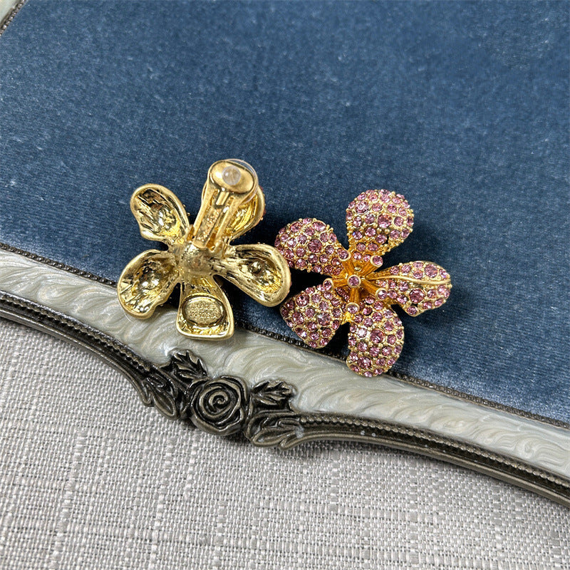 Five-petal flower stud earrings with pink crystal stones on gold-tone setting