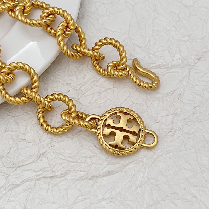 Gold round openwork logo charm on braided links, bracelet/necklace set