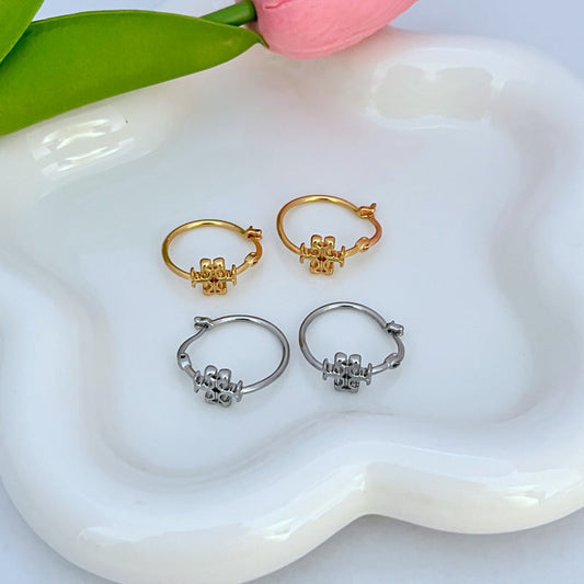 Set of gold- and silver-tone mini hoop earrings with logo charm