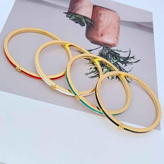 Enamel metal bangles with gold-tone frames and red and green bar details