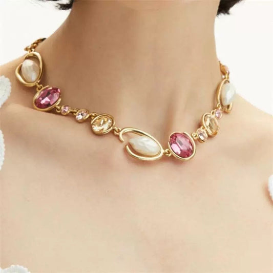 Gold-tone O-ring glass pearl necklace with pink and cream oval charms and links