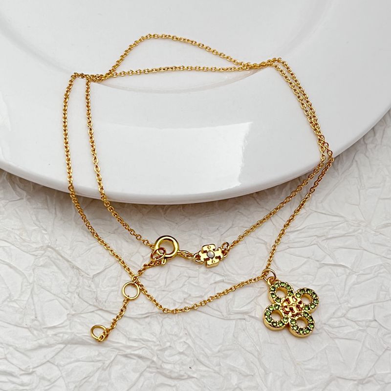Gold tone clover necklace with two four-leaf pendants, rhinestones and ring clasp