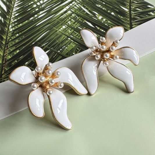Floral enamel earrings with white petals, gold edges, and pearl bead clusters