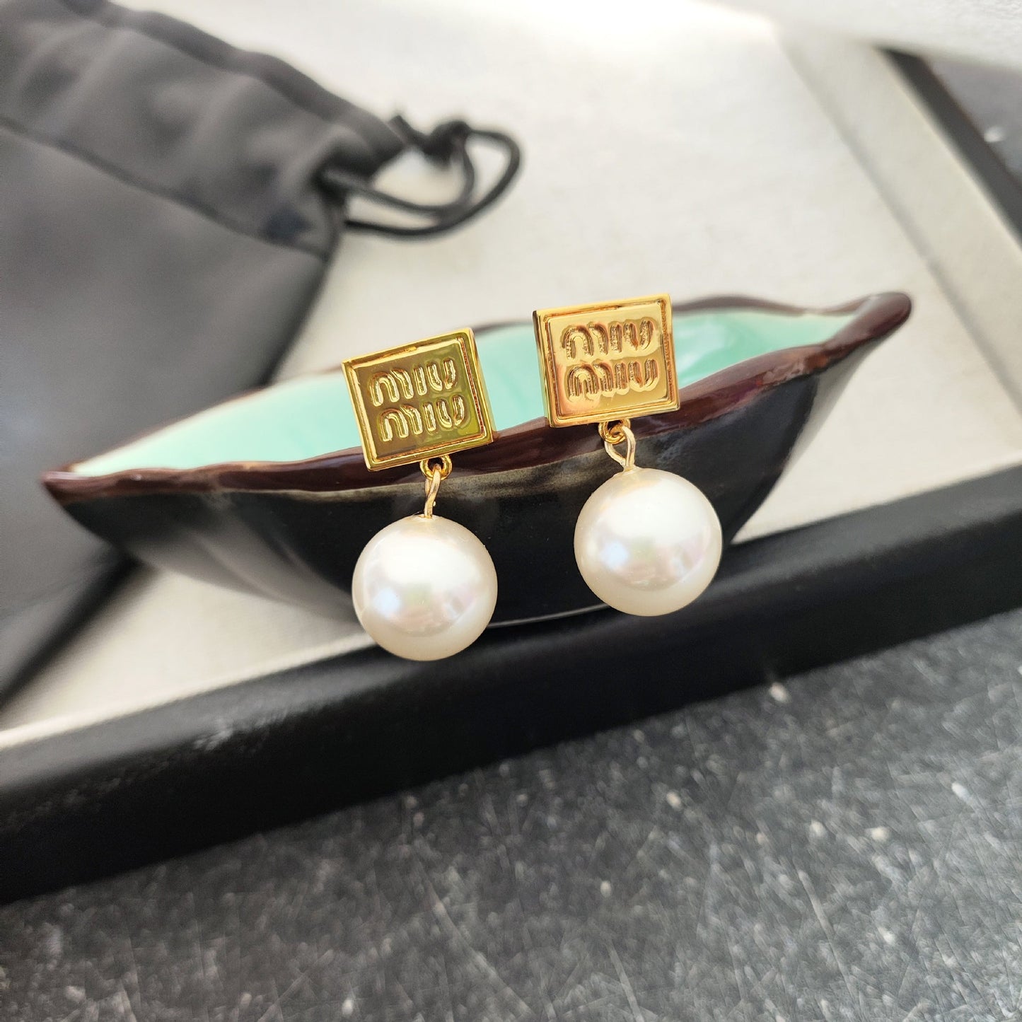 Gold square pendant earrings with lustrous white pearl drops