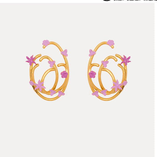 Gold-tone hoop earrings with pink enamel flower charms, pair view