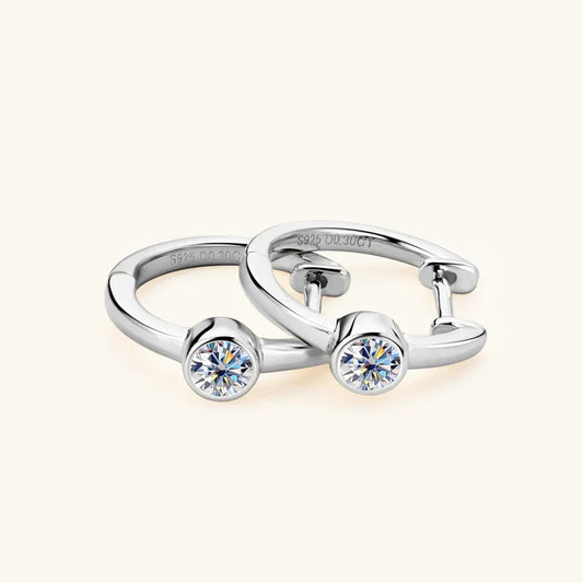 Silver-tone hoop earrings with round solitaire moissanite stones, front view on each hoop.