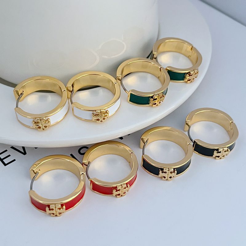 Assorted gold-tone round hoop earrings with enamel bands in green, red, and white