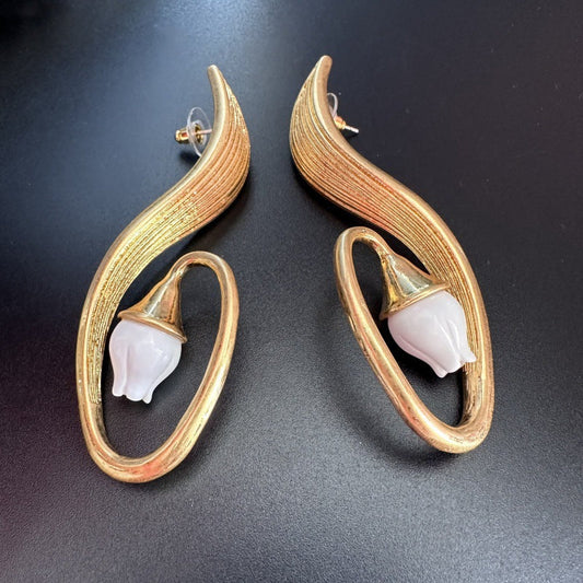 Pair of gold clip-on earrings, crescent hoops with white flower tips