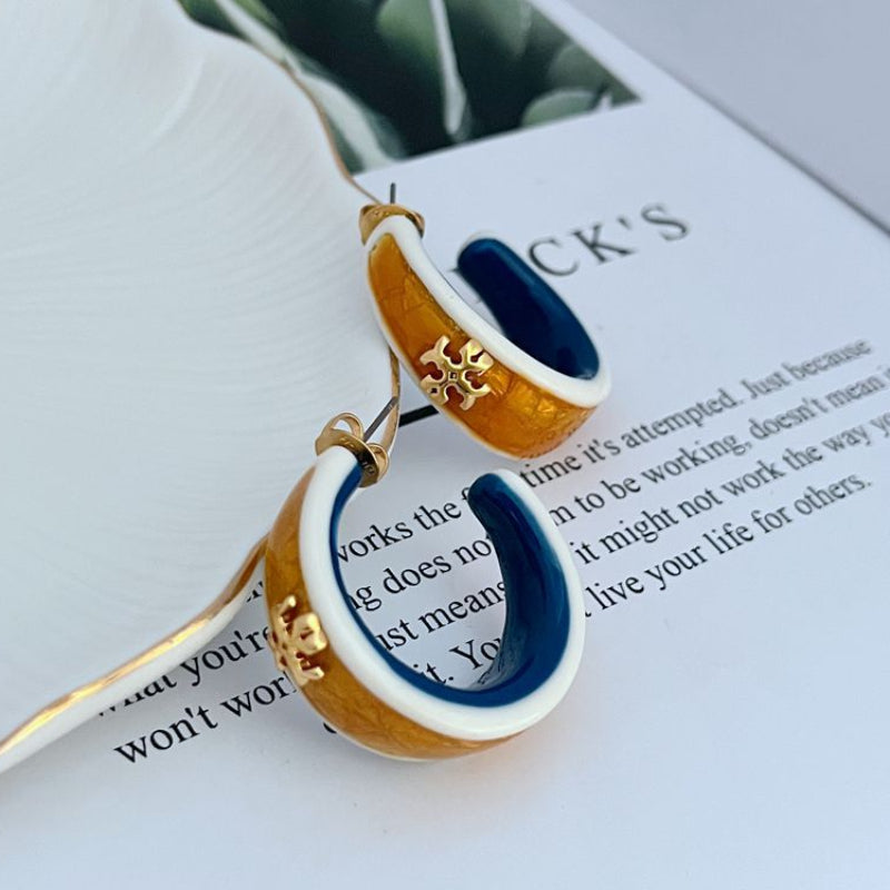 Dangling hoop earrings with white enamel edge, blue center, gold-brown exterior