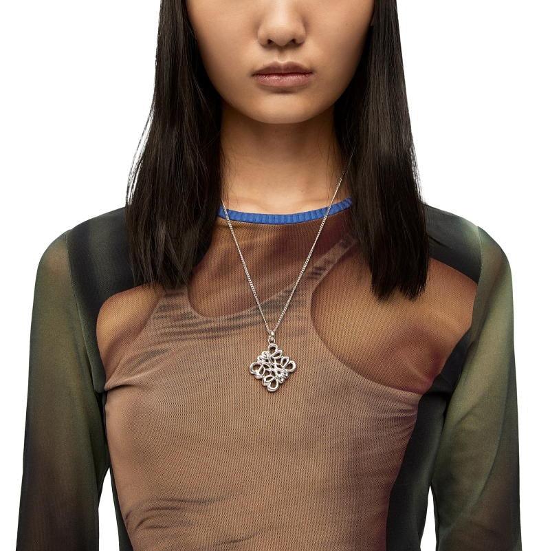 Silver hollow square design pendant necklace worn with a long chain