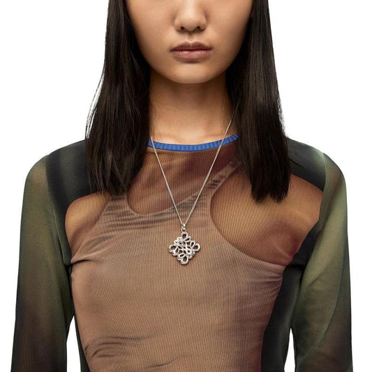 Silver hollow square design pendant necklace worn with a long chain