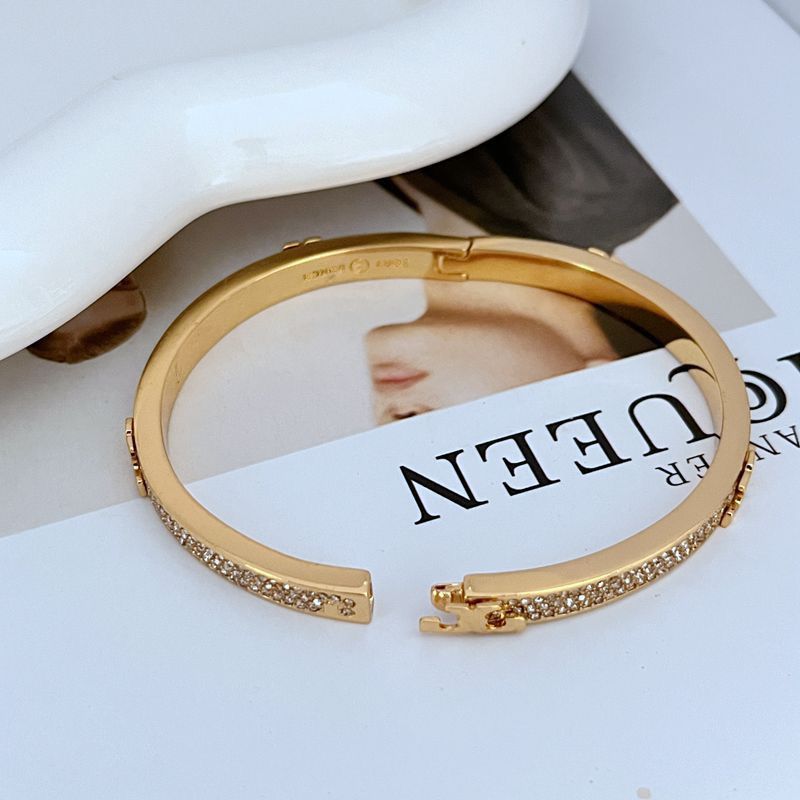 Gold-tone pavé stone openable bangle bracelet with hinge clasp at the side