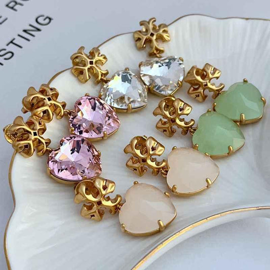 Assorted heart-shaped acrylic earrings: light purple, clear, and milk white with gold-tone frames