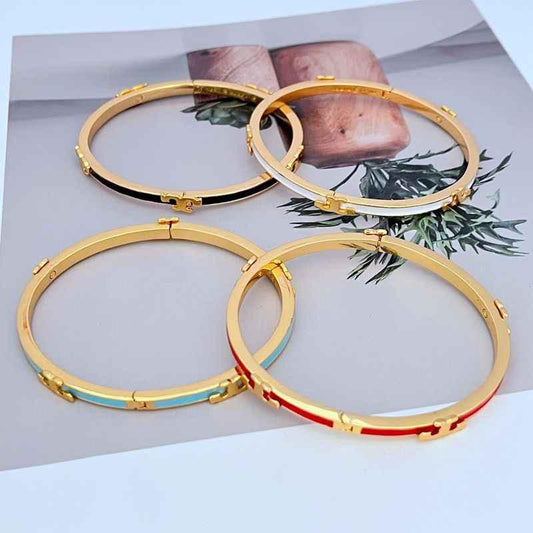 Set of enamel T motif bangles in gold-tone with contrasting inner bands