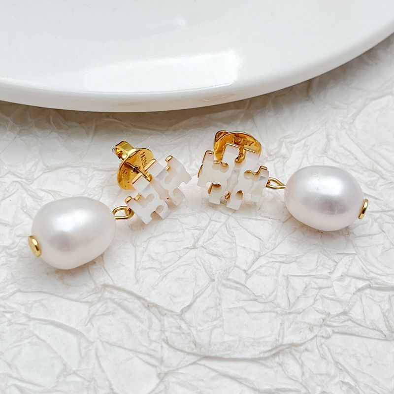 Pair of white pearl drop earrings with seashell-style white details and gold caps