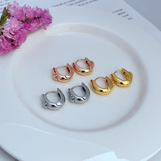 U-shaped hoop earrings showing gold, rose gold, and silver-tone pairs