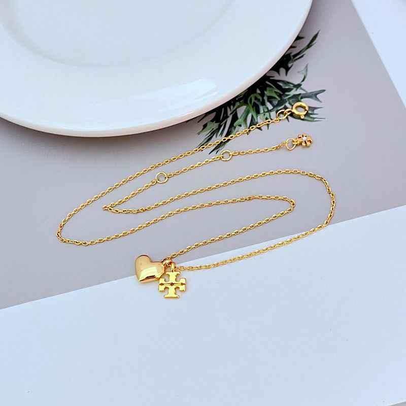 Gold metal heart logo pendant necklace featuring heart charm and logo bar on chain
