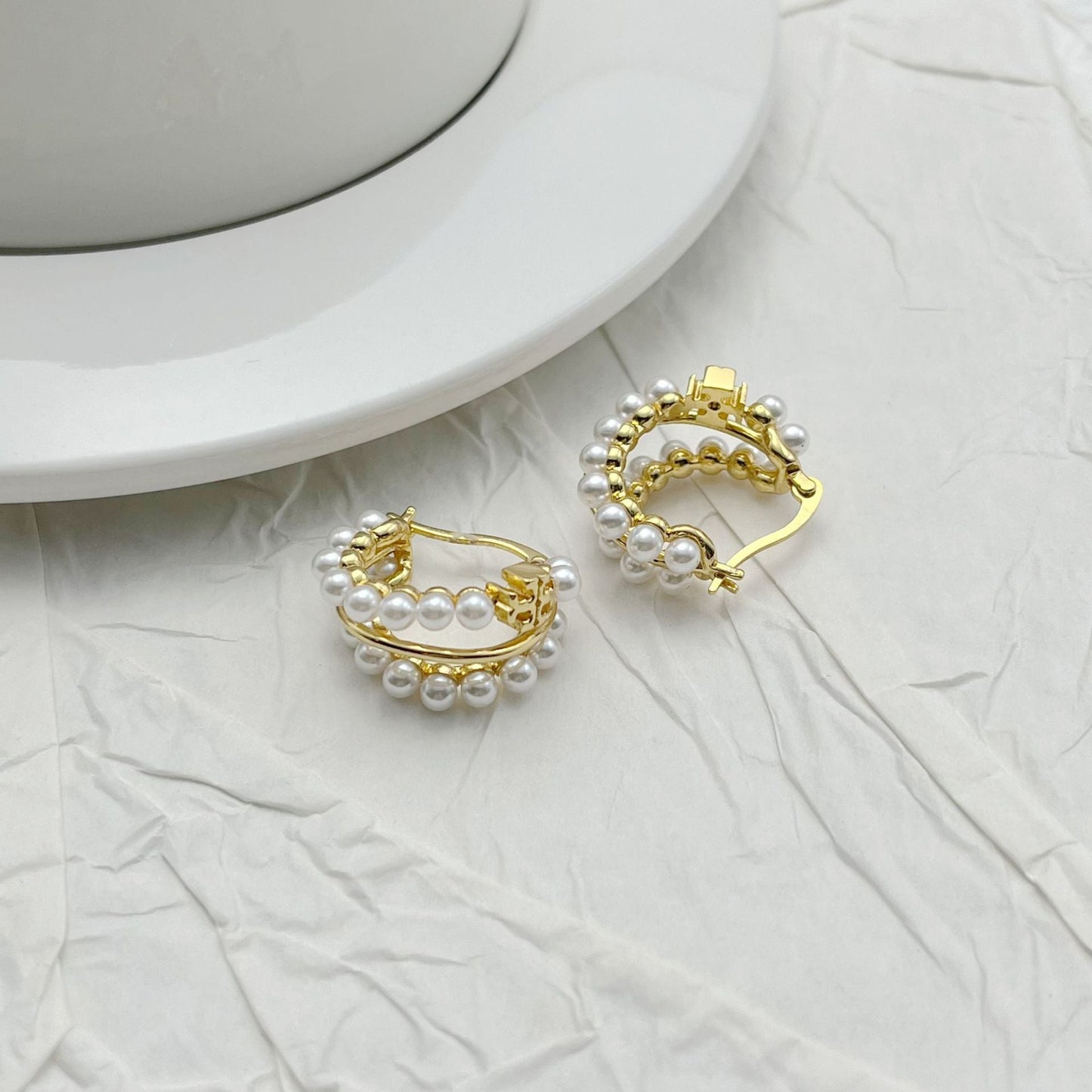 Faux pearl multi-hoop earrings in gold-tone with pearl-bead trim around hoops