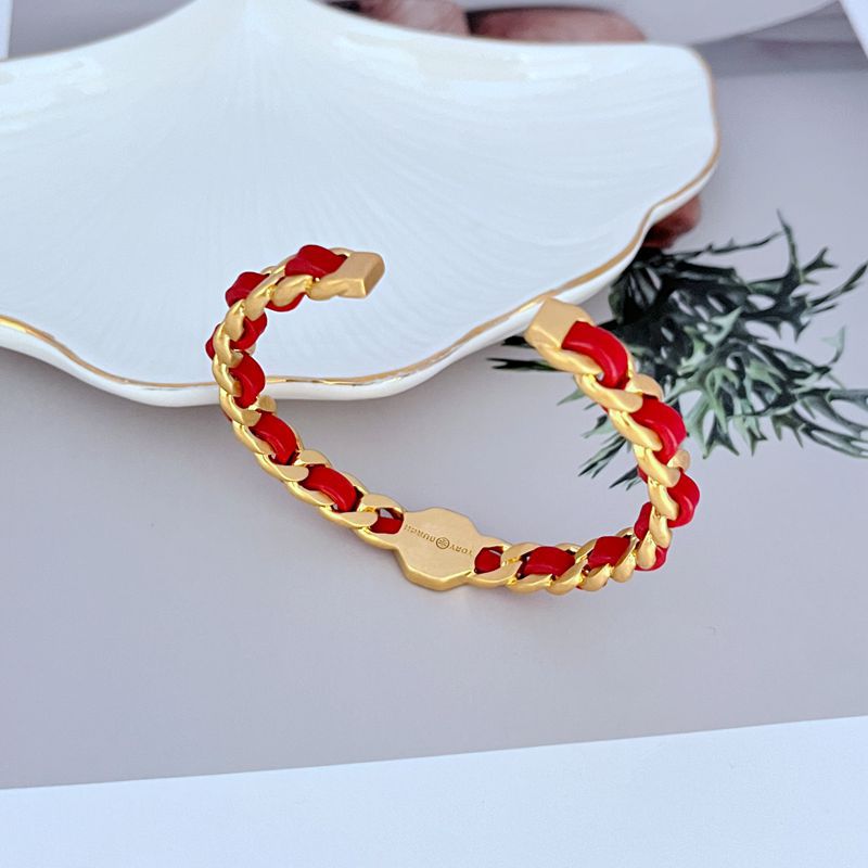 Red woven leather logo open cuff bangle with gold links and square logo plate