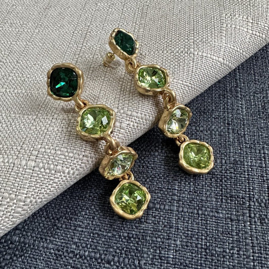 Gold-tone square drop earrings with green crystal accents, multi-link dangle.