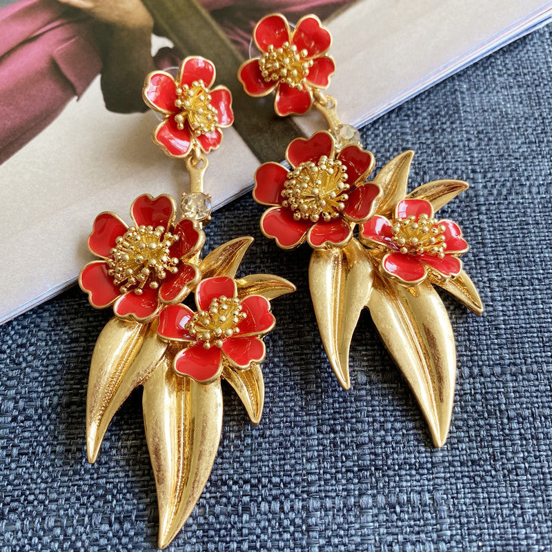 Gold-plated enamel floral drop earrings with red flowers and long tapered drops