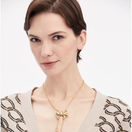 Bow crystal tassel necklace on neckline with dangling round stones