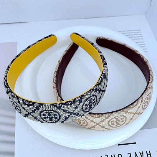 Two logo fabric headbands: navy/white w/ yellow trim and beige w/ burgundy lining