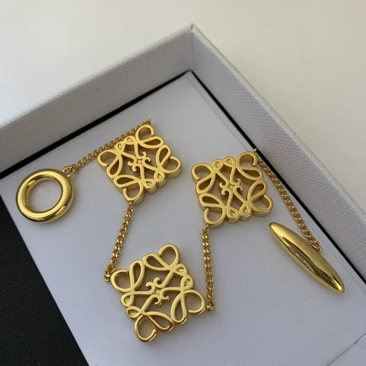 Gold tone geometric openwork square bracelet with chain and round ring clasp