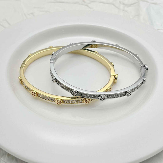 Open cuff bracelets in gold-tone and silver-tone with clear rhinestone bands