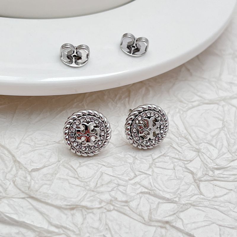 Silver openwork rhinestone stud earrings shown from side, round bezel with crystal halo