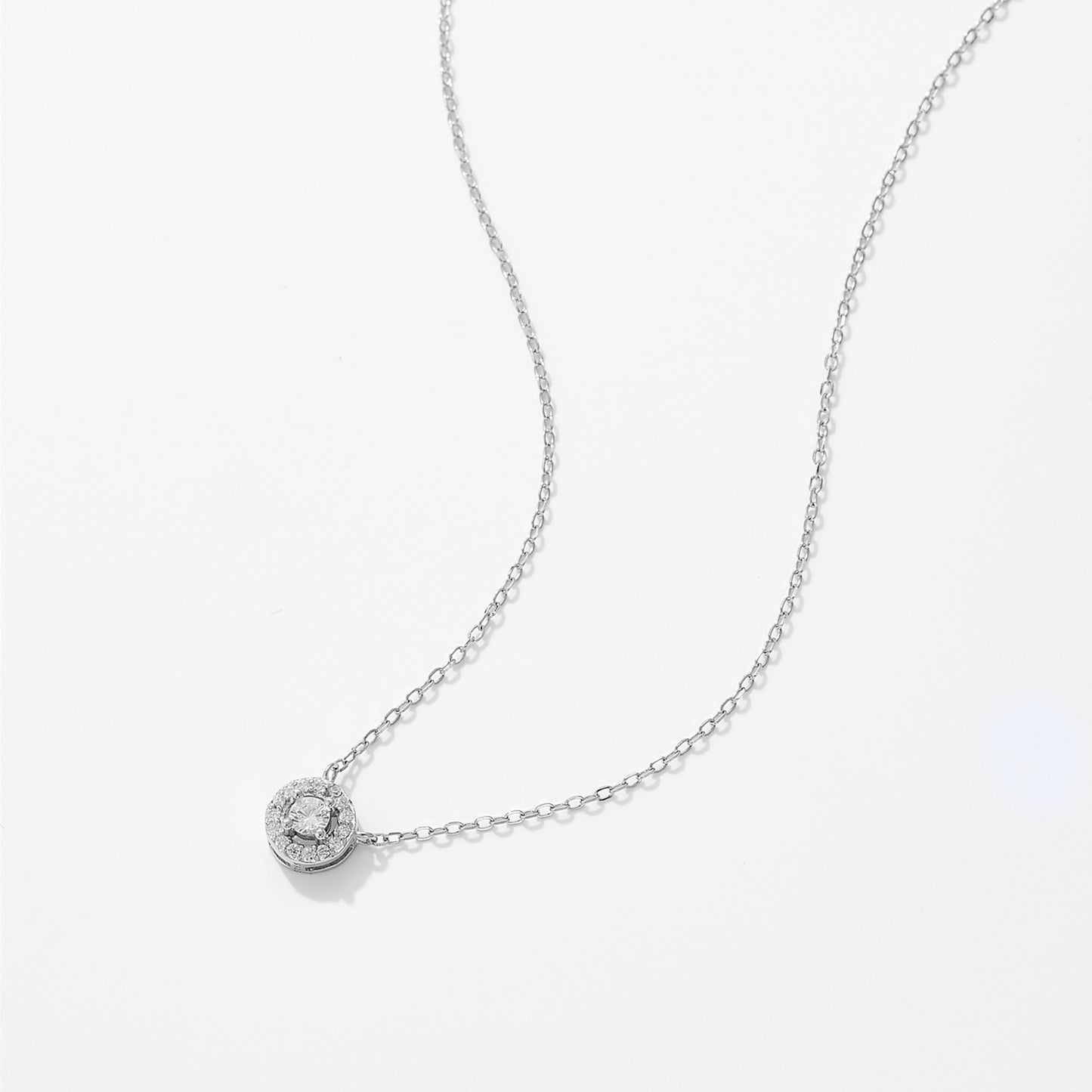 Silver link chain necklace with round zircon pendant featuring detailed crystal setting
