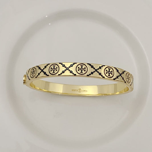 Tory Burch open metal cuff bangle, gold-tone with black enamel lattice logos
