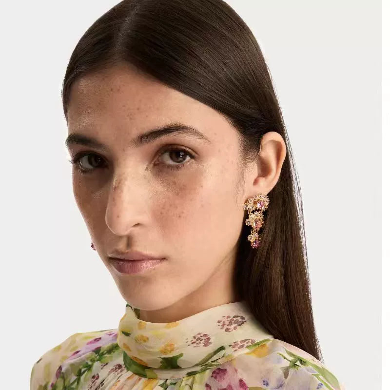 Crystal arched fan-layered stud earrings on model, gold-tone with pink stones