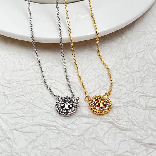 Gold- and silver-tone necklaces with round openwork rhinestone pendant and red center