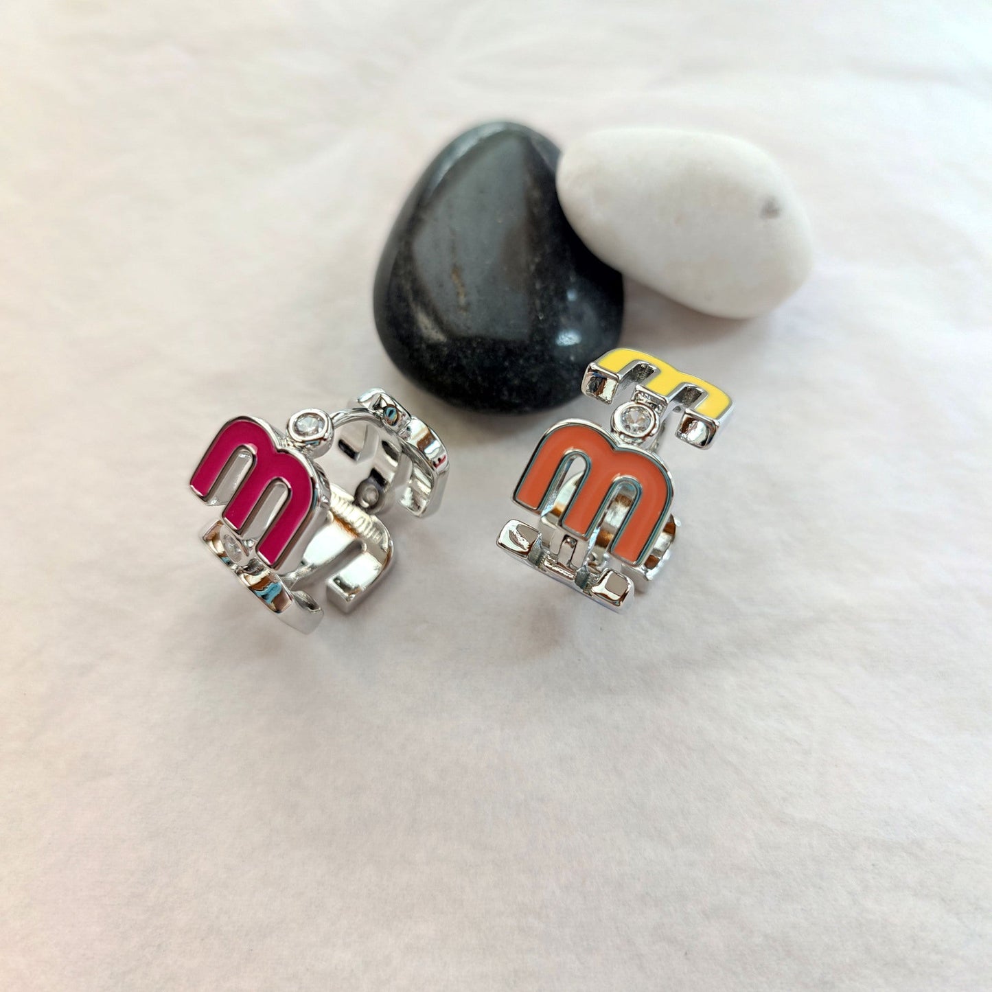 Openwork enamel hoop earrings with multicolor logo panels, silver-tone stud backs