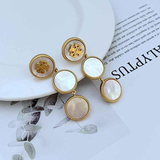 White round shell dangle earrings with gold-tone logo medallions and linked drops