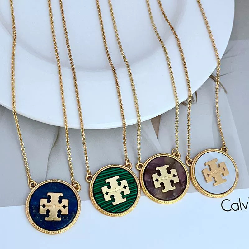 Gold-tone circle coin pendant necklace set with blue, green, purple, and light coin charms
