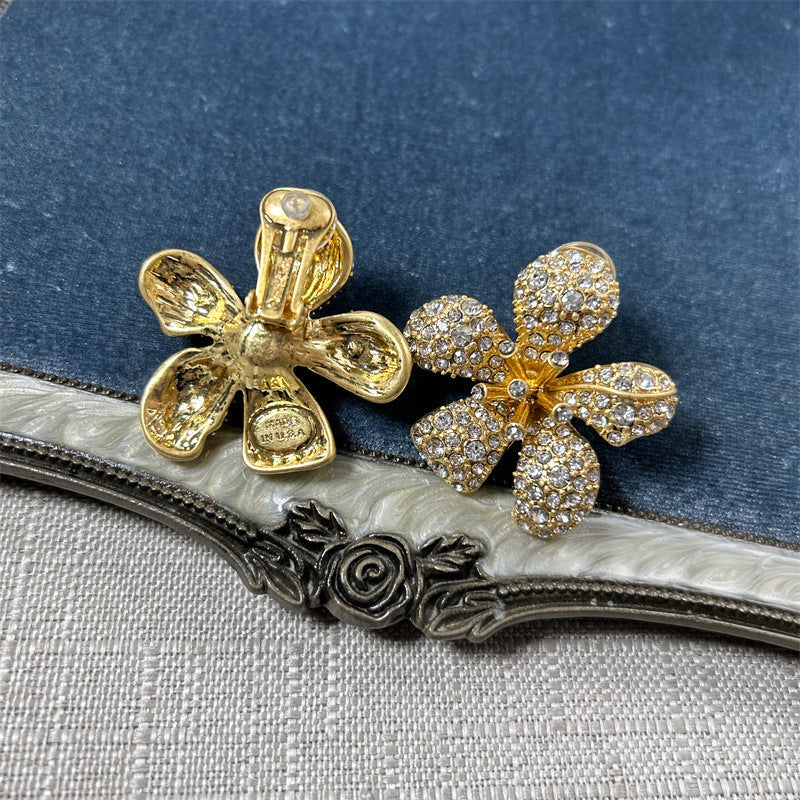 Five-petal flower stud earrings with clear crystal pavé on gold-tone setting