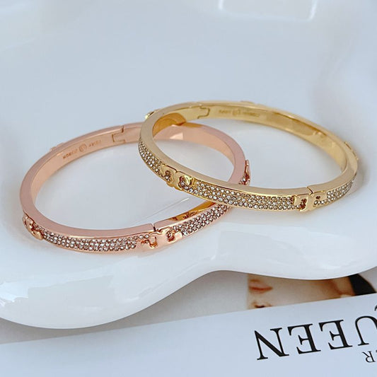 Rose gold-tone pave diamond openable bangle with pavé row and hinged clasp hardware