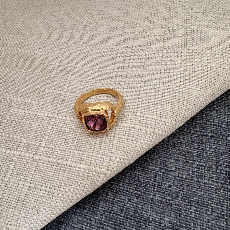 Purple square gemstone ring with gold-tone textured band and prong-set setting
