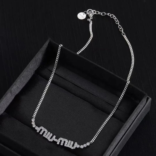 Logo link chain necklace with silver-tone chain and rhinestone “miu miu” pendant