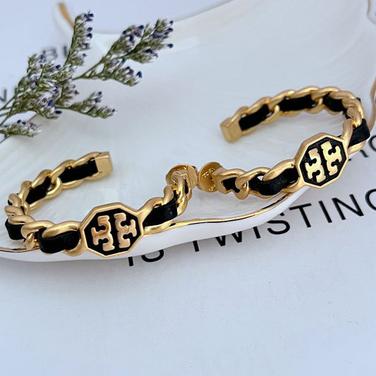 Leather-woven logo hoop earrings with black leather links and gold-tone logo medallions