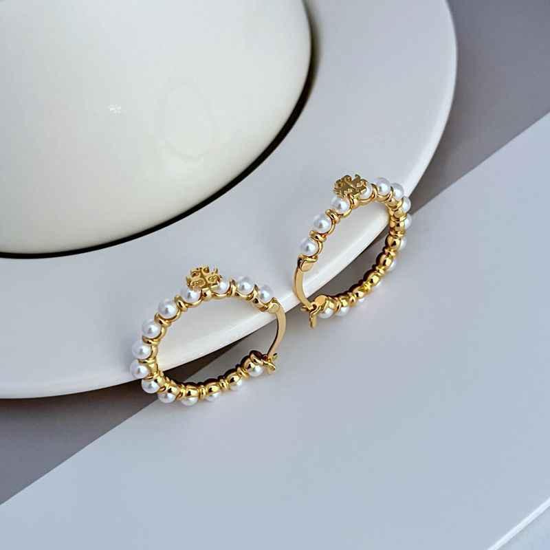 Gold hoop earrings with faux pearls and front logo medallion detail