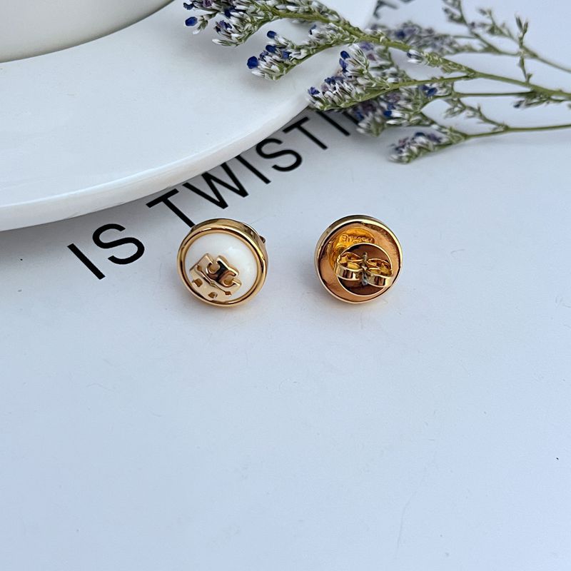 Gold-tone round resin logo stud earrings, white face and gold back detail